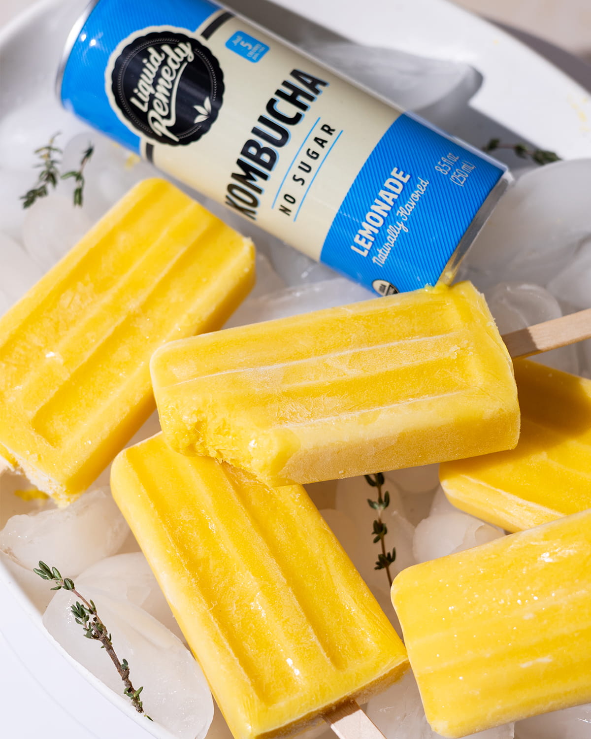 Lemonade Kombucha Popsicles next to a Liquid Remedy Kombucha can