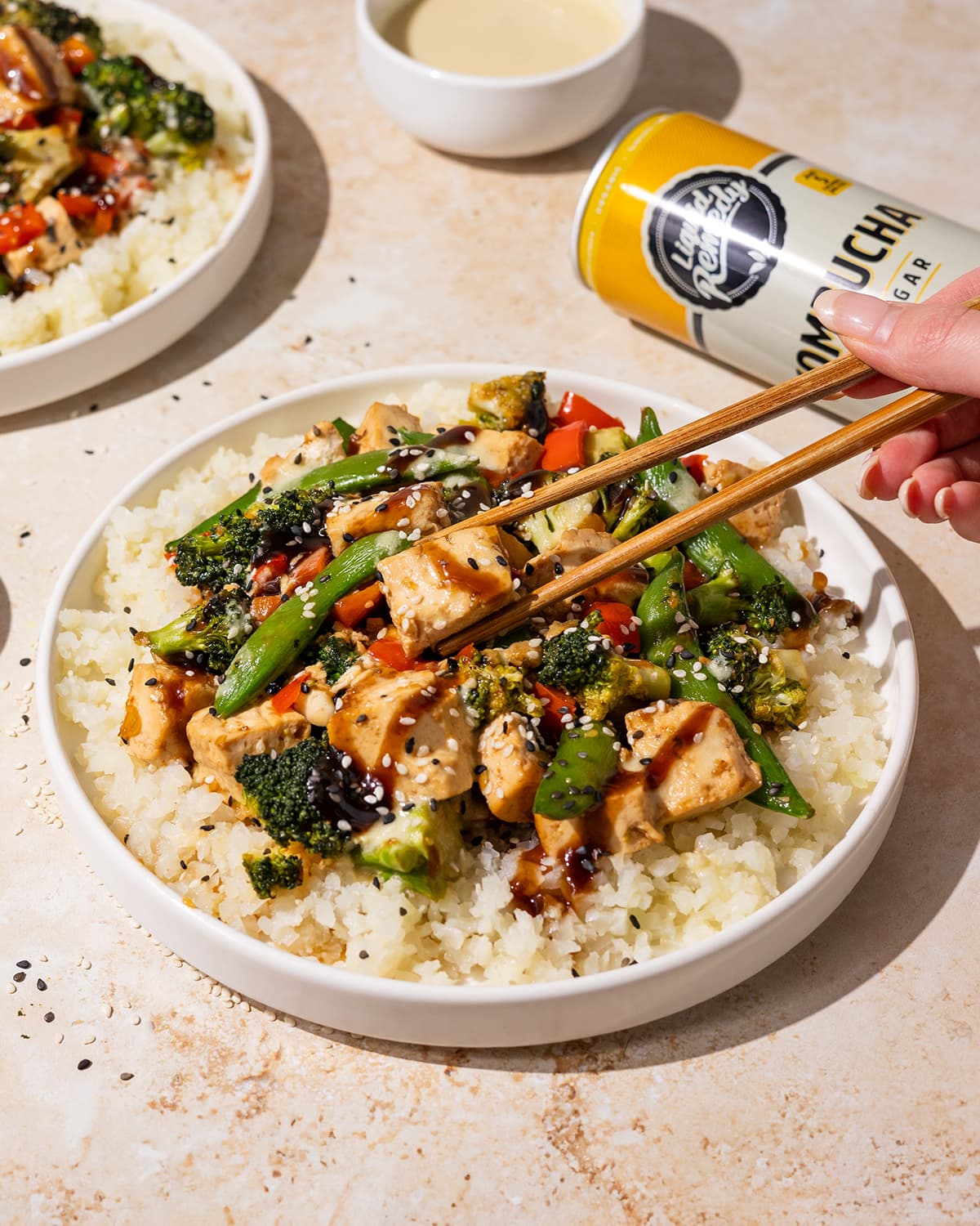 Ginger Lemon Stir Fry next to a Liquid Remedy Kombucha can